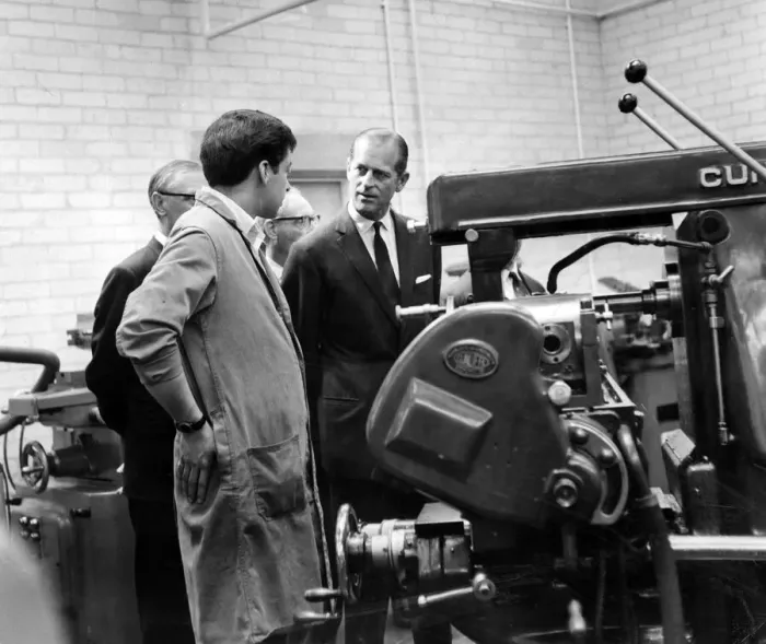 Framed Print : Prince Philip, Duke of Edinburgh talks to 20-year-old Russell Thomas as he operates a Framed Print : Prince Philip, Duke of Edinburgh talks to 20-year-old Russell Thomas as he operates a