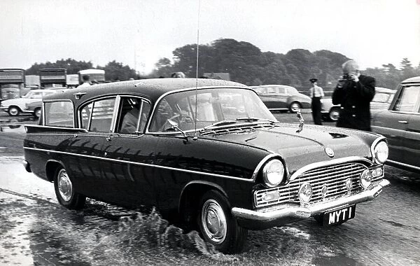 Prince Philip leaving Smiths field polo ground in his car after a storm. June 1963
