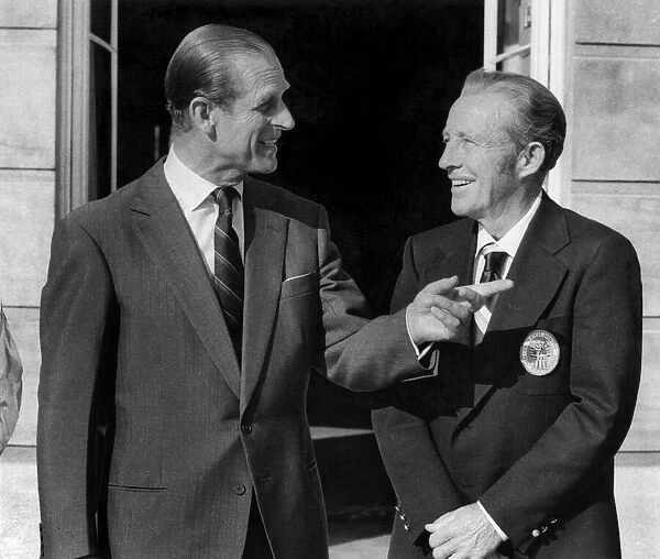 Prince Philip (left) makes a point during his chat with Bing Crosby. July 1976 P009341