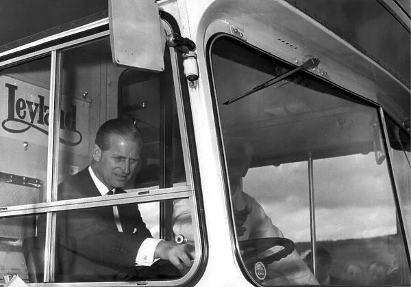 Prince Philip at the wheel of a double decker bus during his visit to the Leyland works