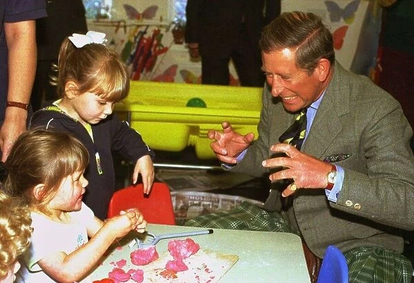 The Prince of Wales jokes with children Lauren Davies, left, aged two