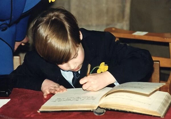 Prince William signing his name in the visitors book of Llandaff Cathedral in Cardiff