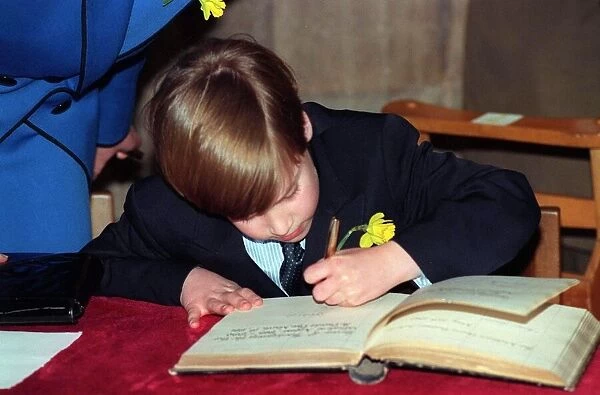 Prince William signing a Visitors Book in Wales on St. Davids Day