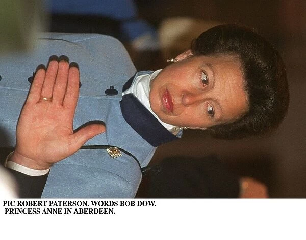 Princess Anne in Aberdeen wearing blue jacket hand in front