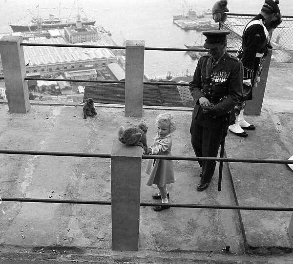 Princess Anne holds her hand out to a Barbary Ape May 1954 on the rock of