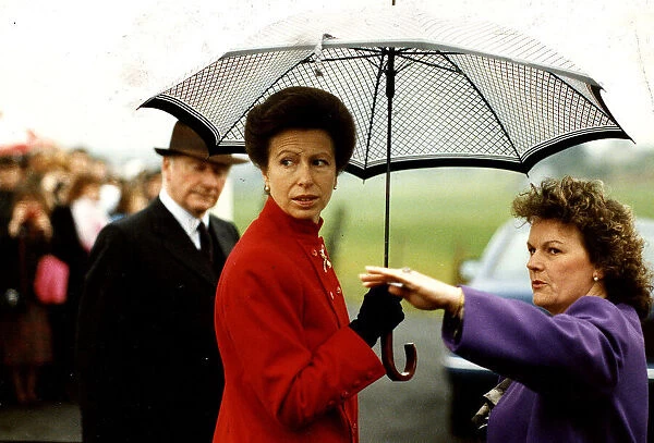 Princess Anne visit to Denny umbrella red coat