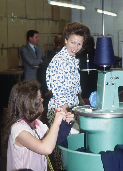 Princess Anne visit to East Kilbride Scotland talking to younh woman at knitting machine