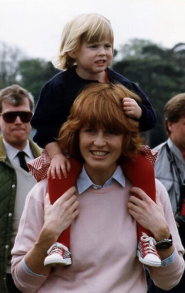 Princess Beatrice being carried by her mother the Duchess of York