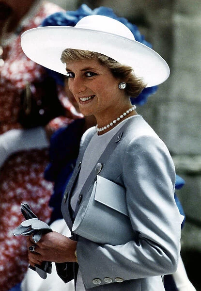 Princess Diana attends the Ascot race meeting wearing a pearl grey silk top coat with