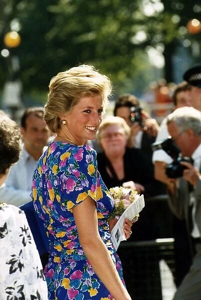 Princess Diana in blue dress with flower pattern holding bouquet of flowers 19th