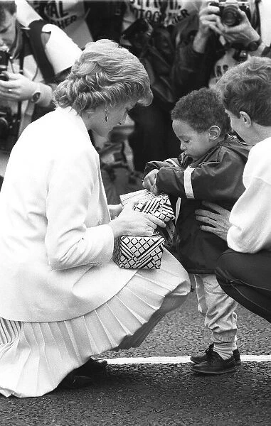 Princess Diana handing out a few surprise gifts to children at the start of the 1988
