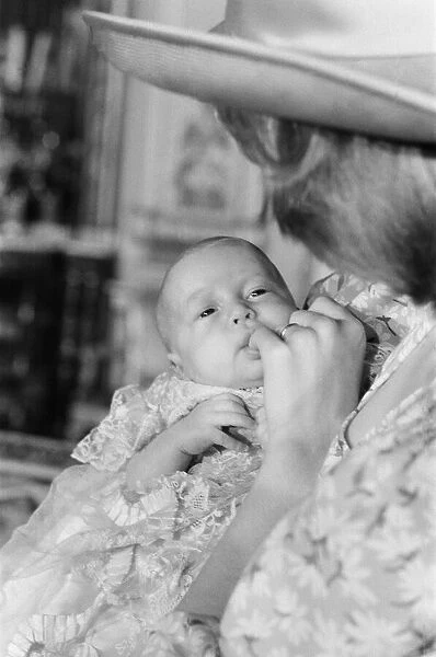 Princess Diana holds her son Prince William in her arms in the White Drawing Room of