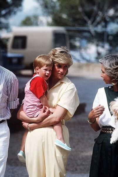 Princess Diana holds her young son Prince Harry on holiday in Majorca, Spain