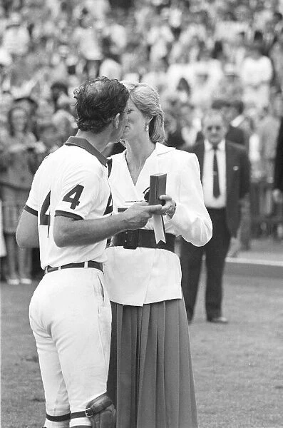 PRINCESS DIANA KISSES PRINCE CHARLES WHILST PRESENTING HIM WITH A POLO TROPHY
