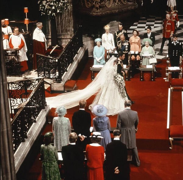 Princess Diana and Prince Charles walking down the isle being watched by both families