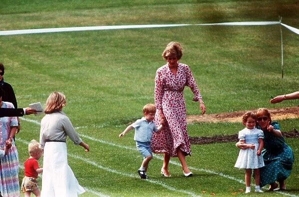 Princess Diana and Prince Harry walk along hand in hand at Prince William