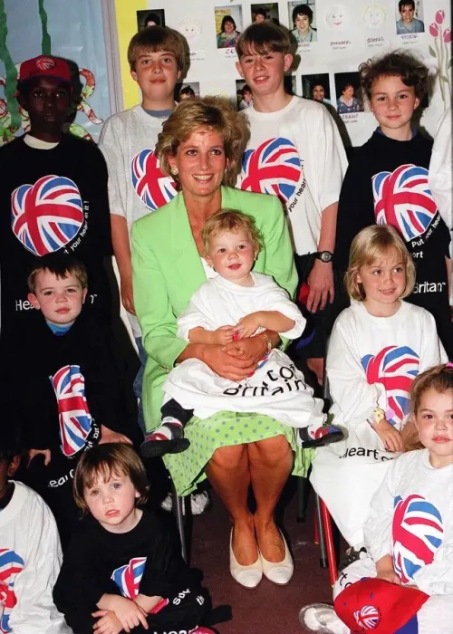 Framed Print : Princess Diana Princess of Wales with James Perry sitting on her knee during a visit to a Framed Print : Princess Diana Princess of Wales with James Perry sitting on her knee during a visit to a