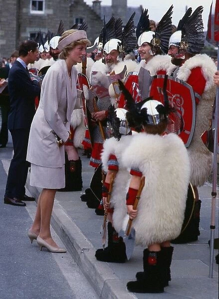 Princess Diana, Princess of Wales, talking to men dressed as vikings on a visit to