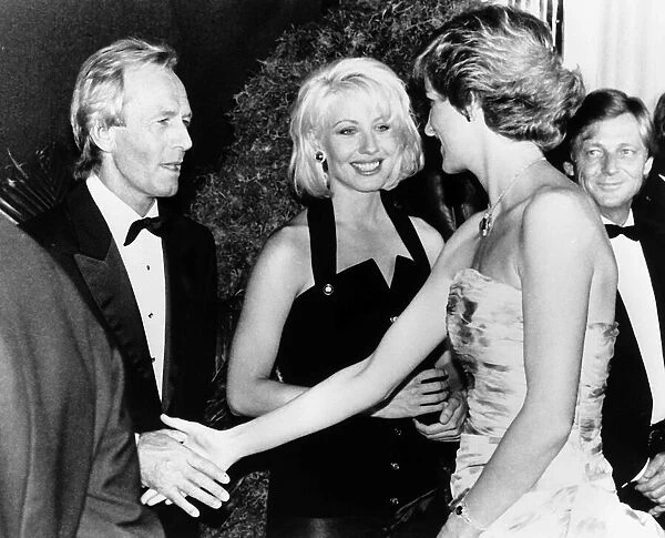 Princess Diana shakes hands with Australian actor Paul Hogan at the premiere of his film