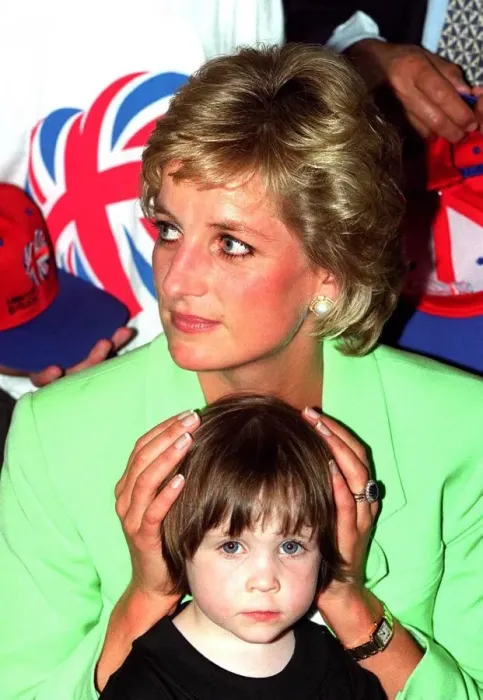 Framed Print : Princess Diana sitting with Caitlin Hines on her lap during a visit to a children