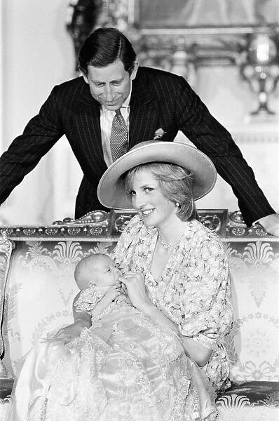 Princess Diana, watched by husband prince Charles, holds her son Prince William in her