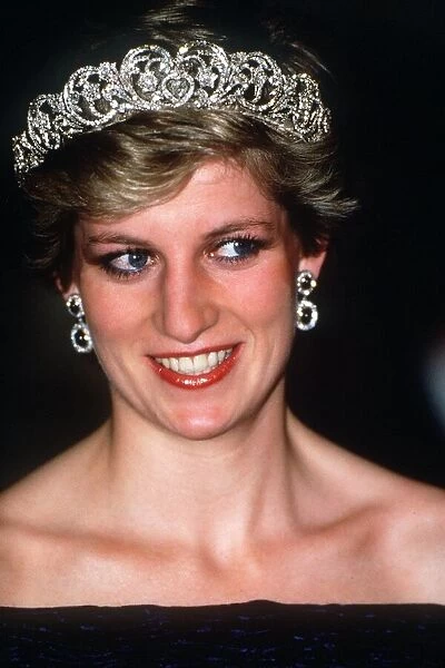 Princess Diana wearing a black dress and tiara attends at a banquet hosted by