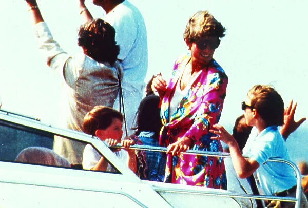 Princess Diana with their two young sons Prince Harry and Prince William on board an