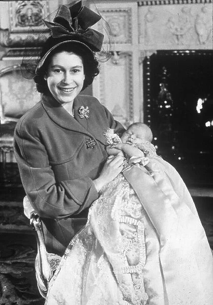 Princess Elizabeth holds her baby son Prince Charles in the drawing room at Buckingham