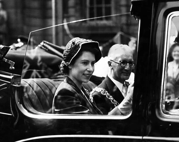 Princess Elizabeth smiles at the crowds along the route during her visit to the West