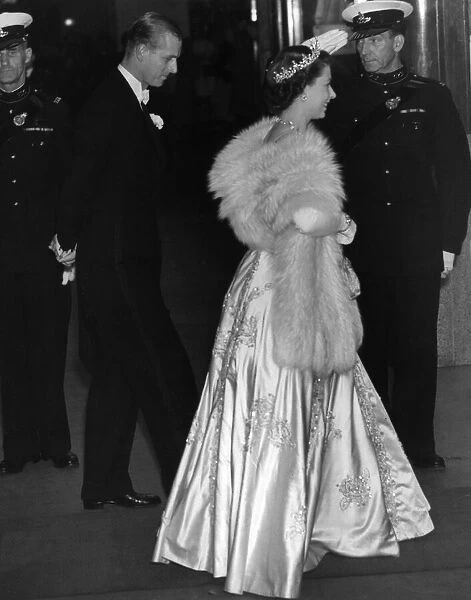 Princess Elizabeth wearing an elegant long dress and fur stoll attends an the premiere of
