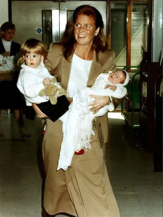 : Princess Eugenie and Princess Beatrice being held by their mother the Duchess Of York : Princess Eugenie and Princess Beatrice being held by their mother the Duchess Of York