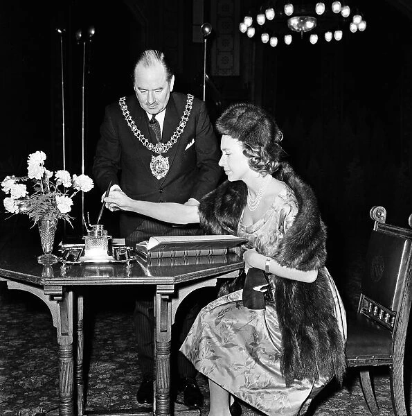 Princess Margaret visits Manchester. Margaret signs the visitors book at Manchester Town