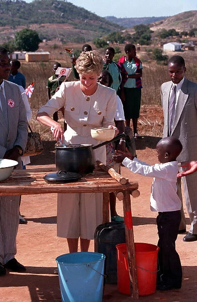 PRINCESS OF WALES DISHING OUT FOOD DURING VISIT TO RED CROSS CHARITY PROJECT IN ZIMBABWE