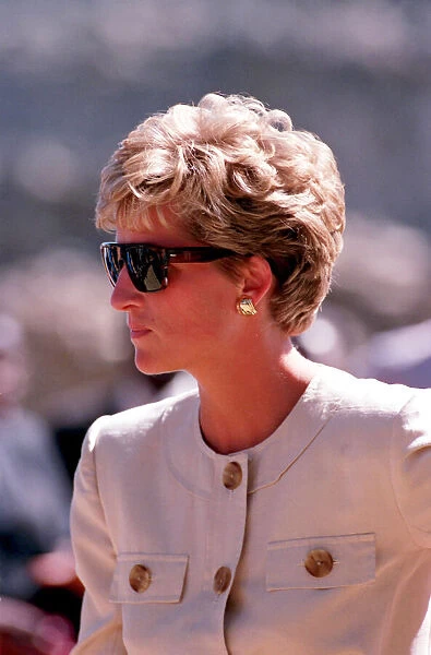 PRINCESS OF WALES WEARING SUNGLASSES AND SMILING DURING A VISIT TO RED CROSS CHARITY