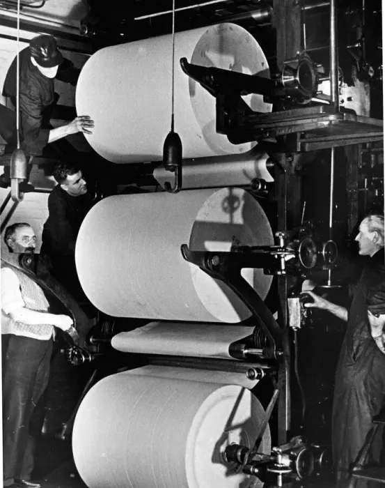 Framed Print : Printers Circa 1950 Reels of paper are loaded and threaded into the printing press