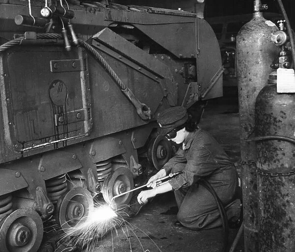Private Mary Lynn wielding a Churchill tank in an Ordnance Depot