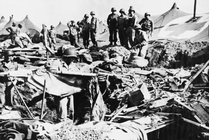 Framed Print : Private Robert Phillips retrieves a cot from a bomb crater after an American hospital Framed Print : Private Robert Phillips retrieves a cot from a bomb crater after an American hospital