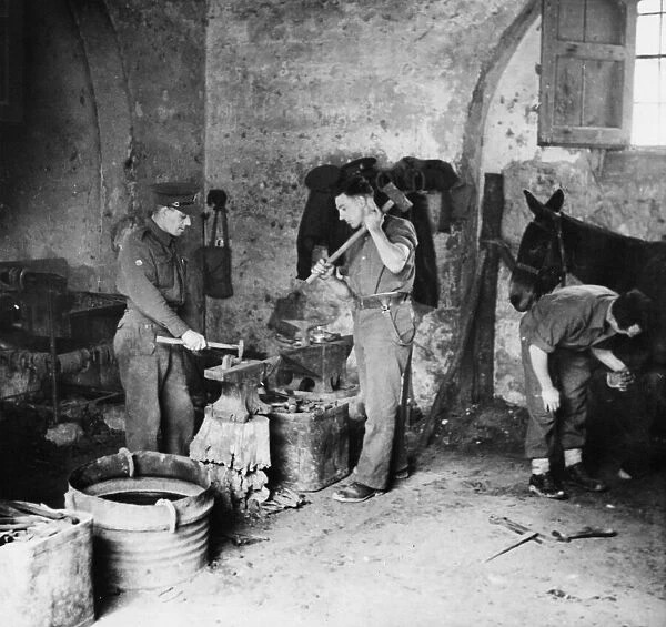 Private W. Day and Farrier H. Jones make horse shoes in Cassino, Italy