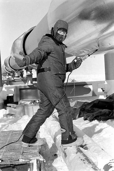 Prudhoe Bay Alaska. Workmen working on the pipeline (insulatingit) at Prudhoe Bay