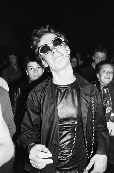 Punk Rocker dancing with safety pin through nose, June 1977