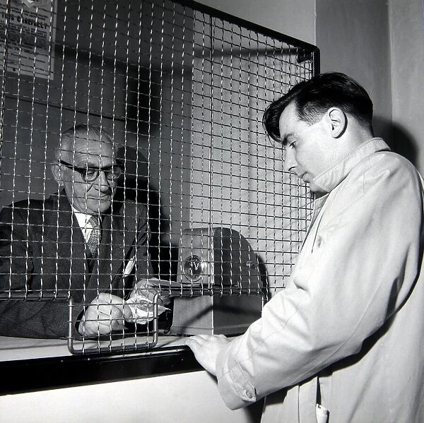 A punter placing a bet at William Massey betting shop in Bethnal Green