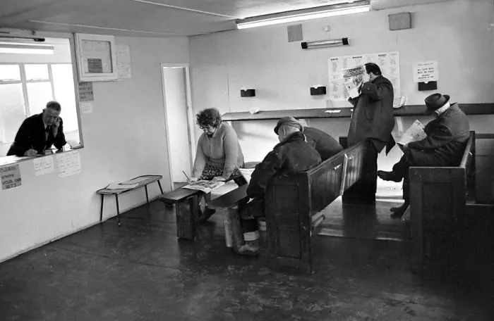 Framed Print : Punters seated on church pews as they study the guide before placing a bet at Mac Framed Print : Punters seated on church pews as they study the guide before placing a bet at Mac