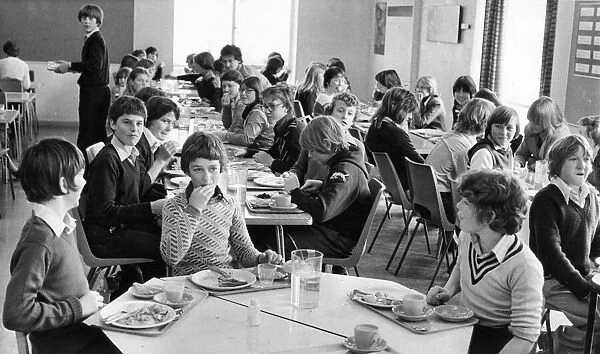 Pupils enjoying their school dinners in a packed dining hall