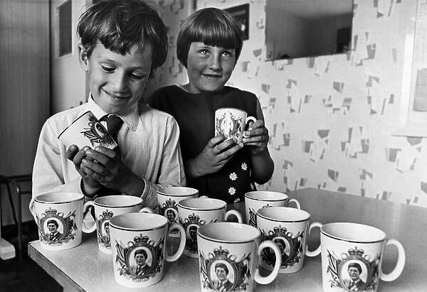 Pupils Ian Graves and Julie Radford admire the mugs presented by Cardiff City Council to