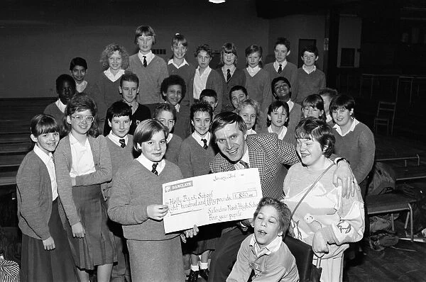 Pupils from Salendine Nook High School, present a cheque for 850 poounds to John Proctor