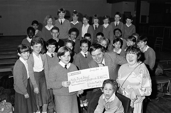 Pupils from Salendine Nook High School, present a cheque for 850 poounds to John Proctor