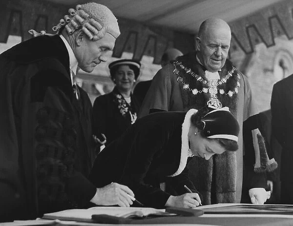 The Queen autographing one of the Royal Portraits at Morecambe with the Mayor Bryce Clegg