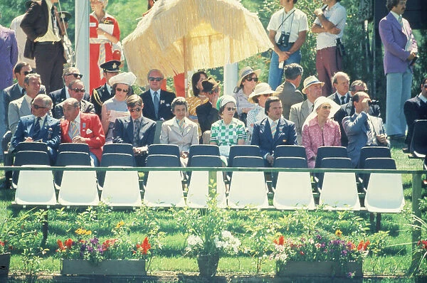 Queen Elizabeth II (4th from the right in the green and white outfit