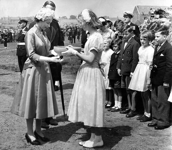 Queen Elizabeth II accepts a gilf of pottery made from Holy Island clay from Margaret
