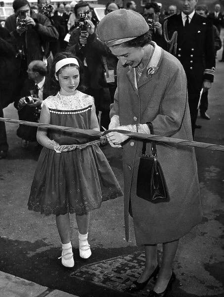 Queen Elizabeth II cuts a ribbon at the Wholesale & Fruit Centre, Cardiff